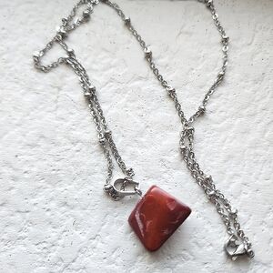 Reddish stone pendant and chain